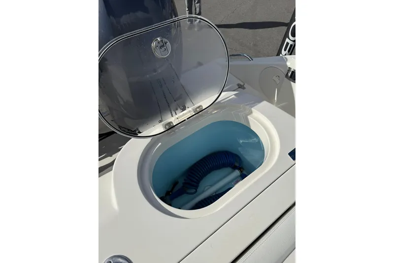 Slide: The Image of Open storage compartment on 2022 Cobia 262 Center Console boat. - 7