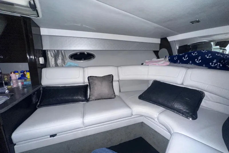 Slide: The Image of Interior of a 2016 Formula 350 Sun Sport boat with white leather seating and nautical decor. - 31