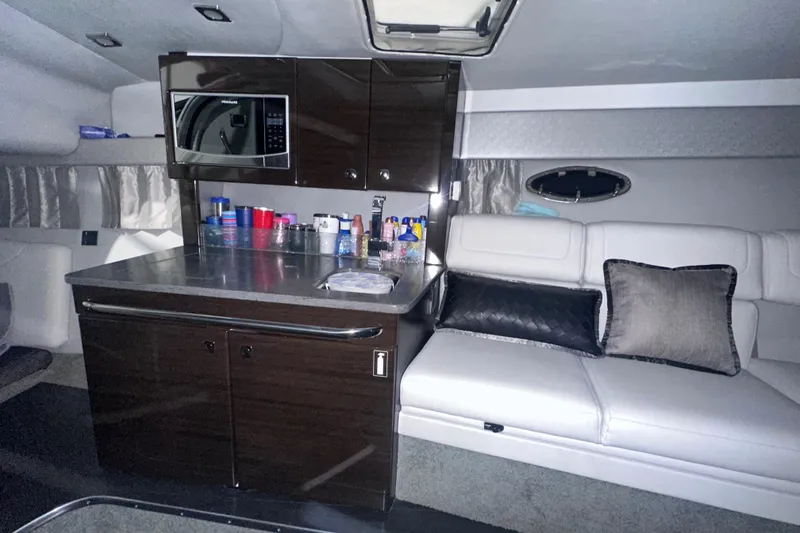 Slide: The Image of Interior of 2016 Formula 350 Sun Sport boat with kitchenette and seating area. - 33