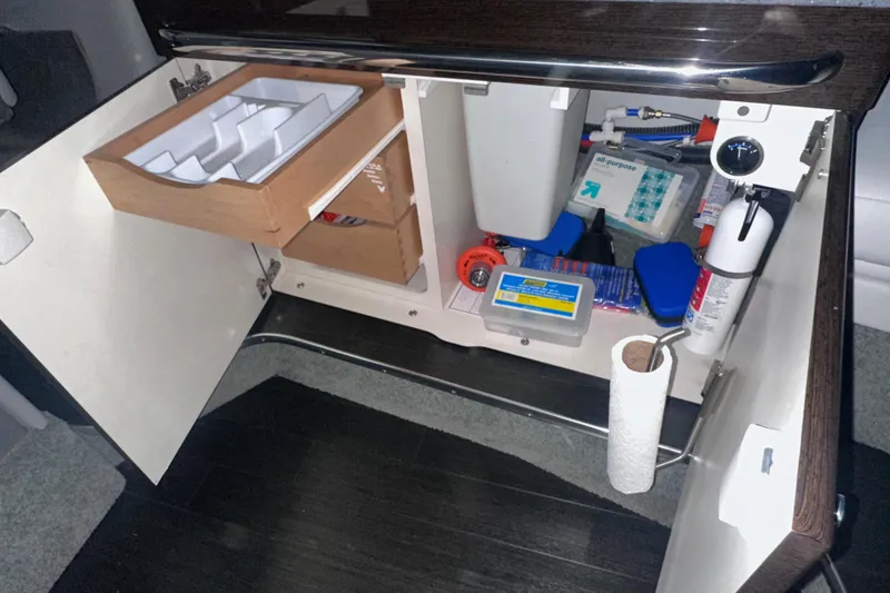 Slide: The Image of Open cabinet in 2016 Formula 350 Sun Sport, showing organized storage with various supplies. - 35