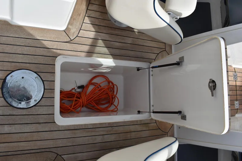 Slide: The Image of Open storage compartment on 2003 Chris-Craft Launch 25 boat with orange extension cord. - 19