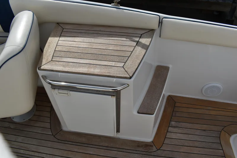 Slide: The Image of 2003 Chris-Craft Launch 25 boat interior with wooden deck and seating area. - 20