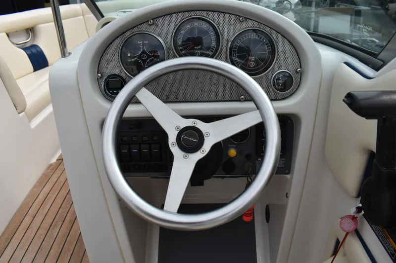 Slide: The Image of 2003 Chris-Craft Launch 25 dashboard with steering wheel and gauges. - 24