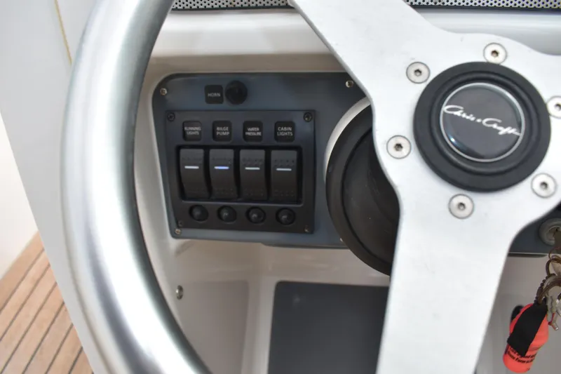 Slide: The Image of Steering wheel and control panel of 2003 Chris-Craft Launch 25 boat. - 26