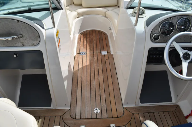 Slide: The Image of 2003 Chris-Craft Launch 25 boat interior with wooden deck and steering wheel. - 27