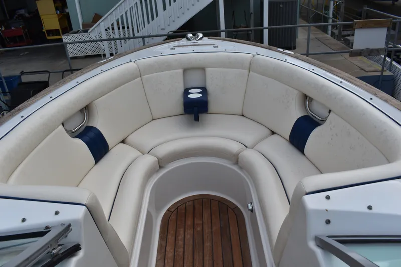Slide: The Image of 2003 Chris-Craft Launch 25 boat with white cushioned seating and wooden flooring. - 35