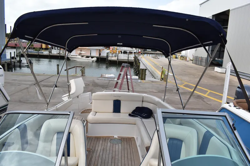 Slide: The Image of 2003 Chris-Craft Launch 25 boat with canopy, docked at marina. - 41