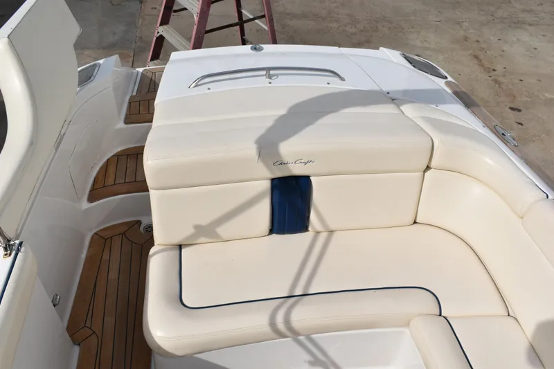 Slide: The Image of 2003 Chris-Craft Launch 25 boat interior with white leather seating and wood accents. - 42