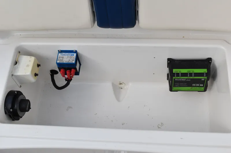 Slide: The Image of 2003 Chris-Craft Launch 25 boat compartment with electrical components and battery charger. - 43