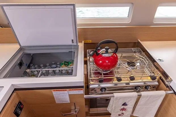 Slide: The Image of Modern kitchen in 2020 Jeanneau Sun Odyssey 410 yacht with stove and fridge. - 10