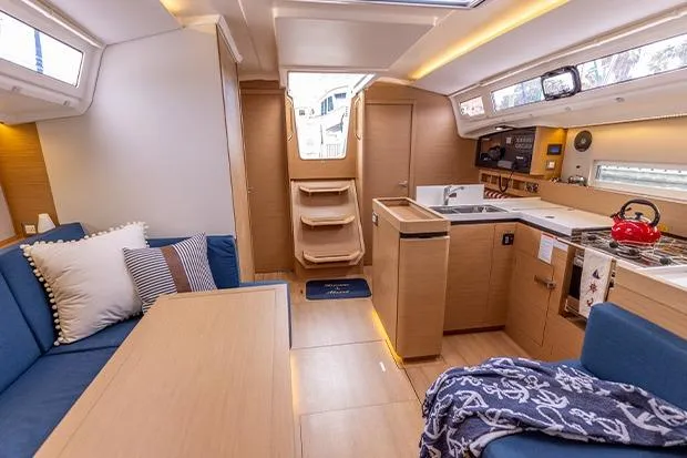 Slide: The Image of Modern interior of 2020 Jeanneau Sun Odyssey 410 yacht with cozy seating and kitchen area. - 11