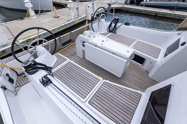 Slide: The Image of 2020 Jeanneau Sun Odyssey 410 sailboat cockpit with dual steering wheels and teak decking. - 4
