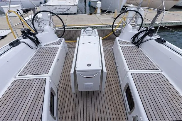Slide: The Image of 2020 Jeanneau Sun Odyssey 410 sailboat cockpit with dual steering wheels and teak decking. - 6