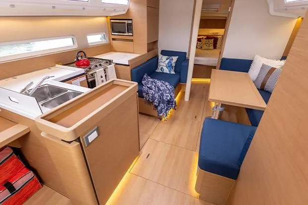 Slide: The Image of Interior of 2020 Jeanneau Sun Odyssey 410 yacht with modern kitchen and cozy seating area. - 7