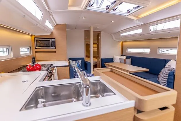 Slide: The Image of Modern interior of 2020 Jeanneau Sun Odyssey 410 yacht with kitchen and seating area. - 8