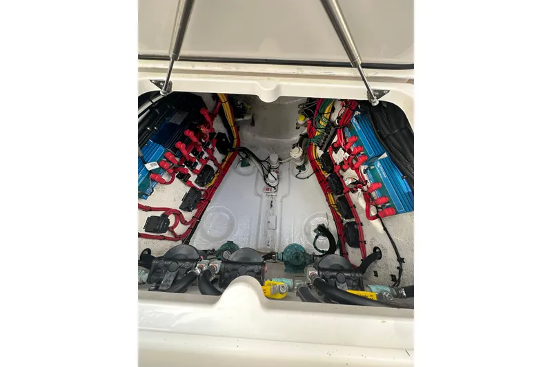 Slide: The Image of Engine compartment of a 2021 Intrepid 409 Valor boat, showcasing wiring and components. - 11