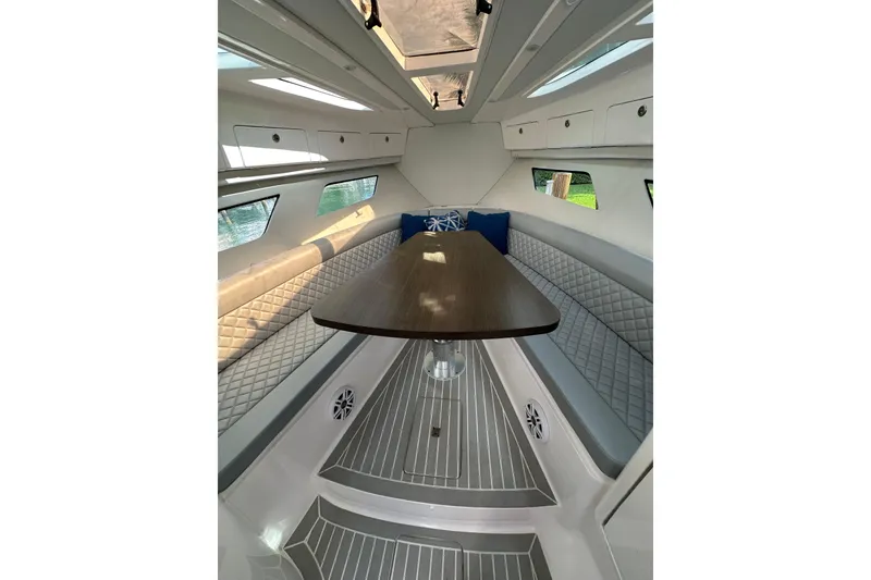 Slide: The Image of Interior of 2021 Intrepid 409 Valor boat with elegant seating and wooden table. - 12