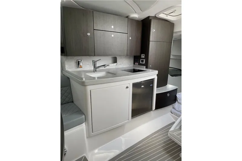 Slide: The Image of 2021 Intrepid 409 Valor yacht interior kitchen with modern cabinetry and appliances. - 13