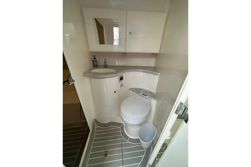 Slide: The Image of Modern bathroom in 2021 Intrepid 409 Valor boat with sleek design and compact amenities. - 15