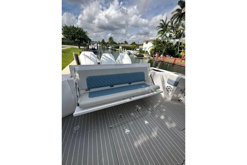 Slide: The Image of 2021 Intrepid 409 Valor boat with cushioned seating and sleek deck design. - 19