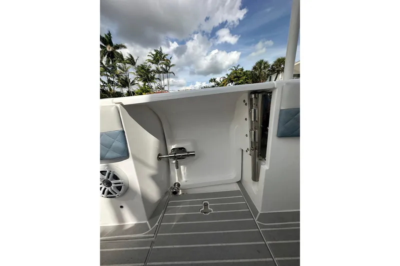 Slide: The Image of 2021 Intrepid 409 Valor boat interior with speaker and ladder, under a cloudy sky. - 20