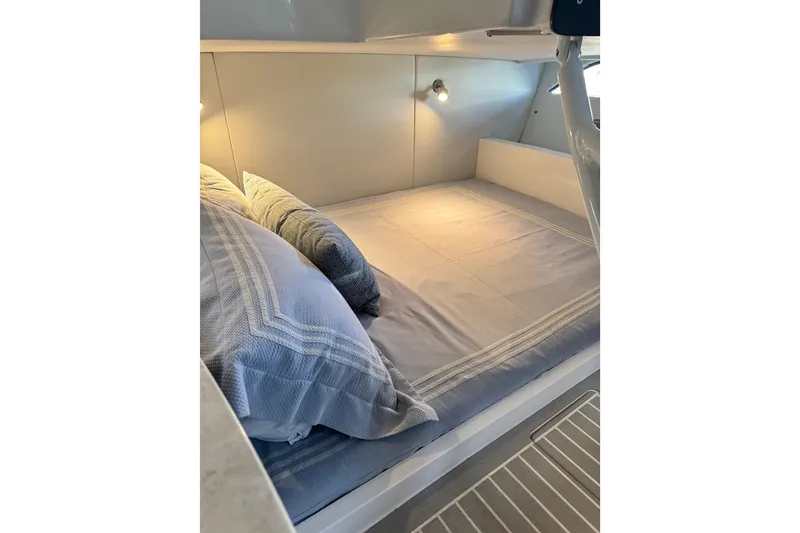 Slide: The Image of 2021 Intrepid 409 Valor cabin with cozy bed and soft lighting. - 26