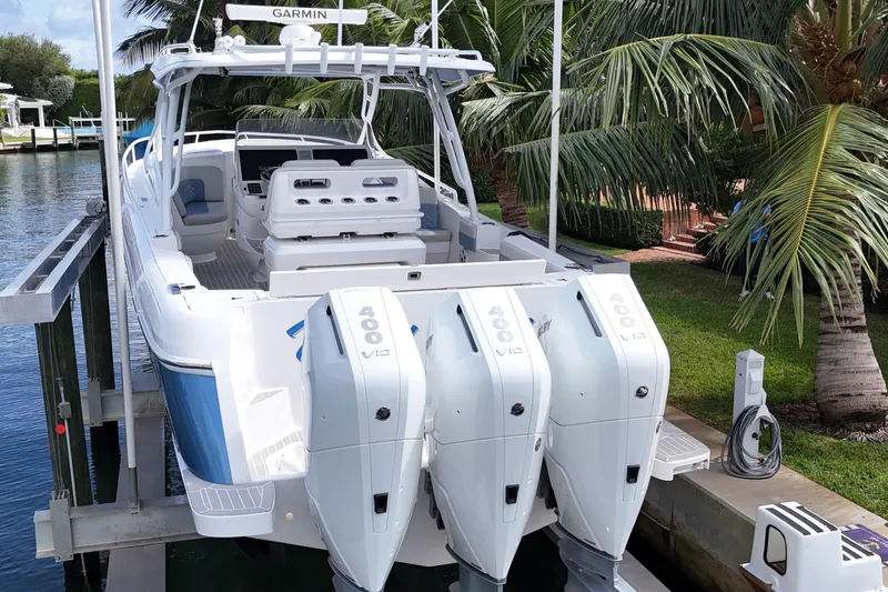 Slide: The Image of 2021 Intrepid 409 Valor boat with triple 400 V10 engines docked near palm trees. - 7