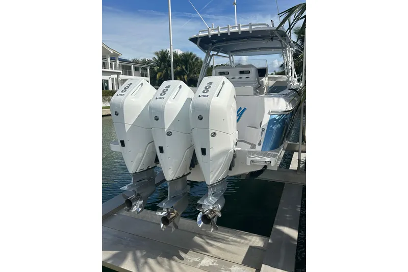 Slide: The Image of 2021 Intrepid 409 Valor boat with triple 400 V10 engines docked by waterfront. - 8