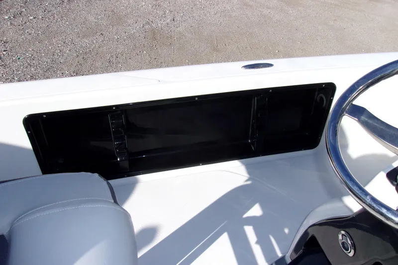 Slide: The Image of 2017 Blue Wave 2200 PureBay boat console with steering wheel and storage compartment. - 11