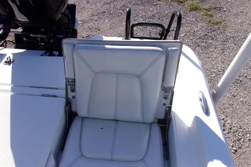 Slide: The Image of 2017 Blue Wave 2200 PureBay boat seat with white upholstery and rear motor view. - 13