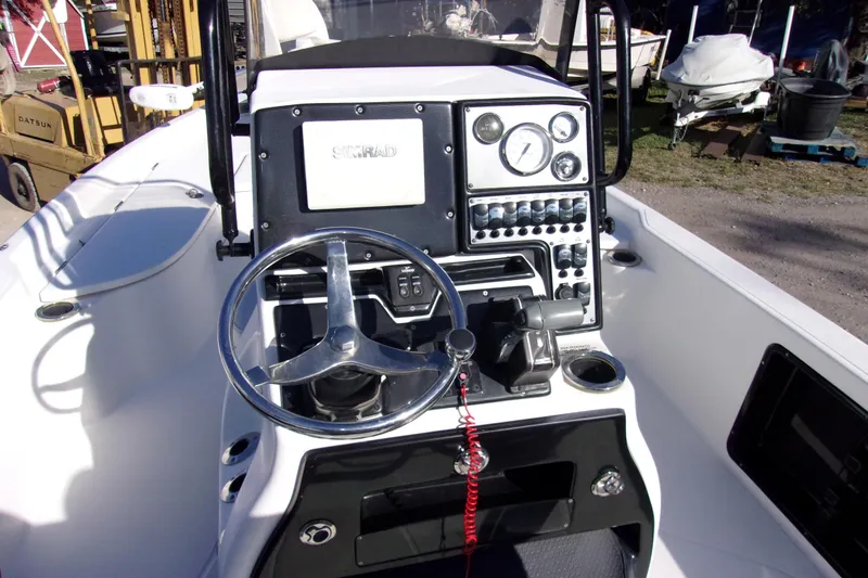 Slide: The Image of 2017 Blue Wave 2200 PureBay boat console with steering wheel and control panel. - 5