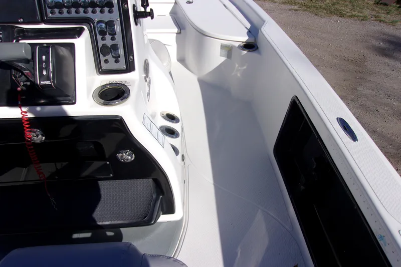 Slide: The Image of 2017 Blue Wave 2200 PureBay boat interior with control panel and seating area. - 9