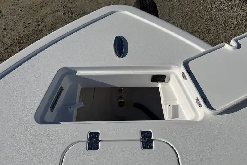 Slide: The Image of 2026 Sportsman Masters 247OE Bay Boat storage compartment with open hatch on deck. - 10