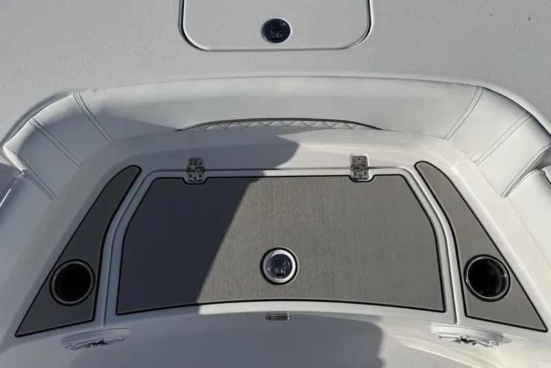 Slide: The Image of 2026 Sportsman Masters 247OE Bay Boat deck with storage compartment and cup holders. - 11