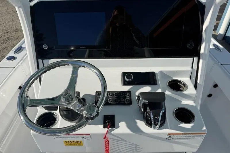 Slide: The Image of 2026 Sportsman Masters 247OE Bay Boat dashboard with steering wheel and controls. - 18