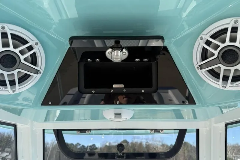 Slide: The Image of 2026 Sportsman Masters 247OE Bay Boat audio system with dual speakers and storage compartment. - 20