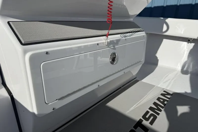 Slide: The Image of 2026 Sportsman Masters 247OE Bay Boat interior with storage compartment and branding. - 21