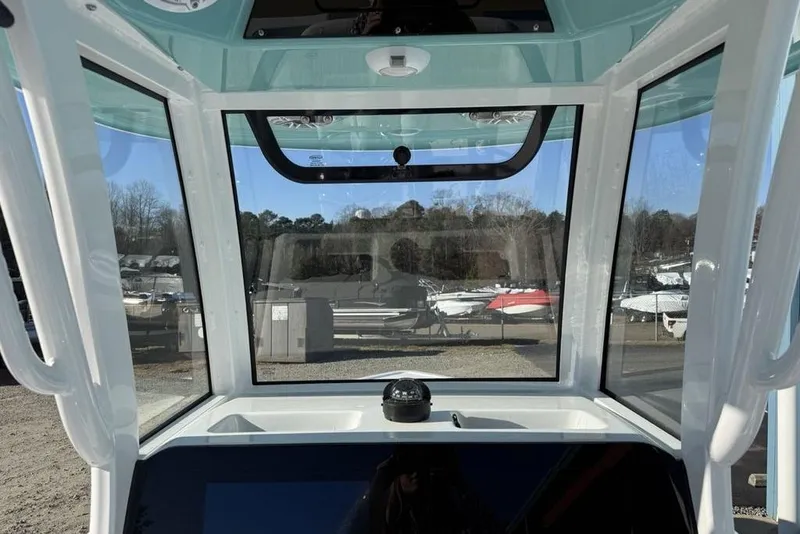 Slide: The Image of Interior view of 2026 Sportsman Masters 247OE Bay Boat cockpit with clear windows. - 24