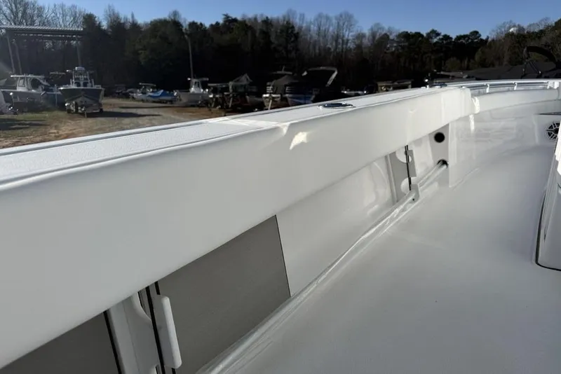 Slide: The Image of 2026 Sportsman Masters 247OE Bay Boat interior, showcasing sleek white design and spacious deck. - 25