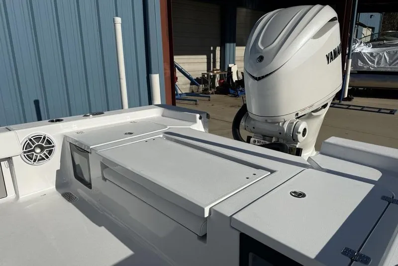 Slide: The Image of 2026 Sportsman Masters 247OE Bay Boat with Yamaha outboard engine, docked near blue building. - 30