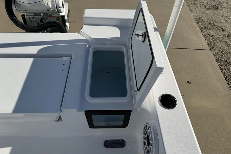 Slide: The Image of 2026 Sportsman Masters 247OE Bay Boat with open storage compartment and speaker. - 35