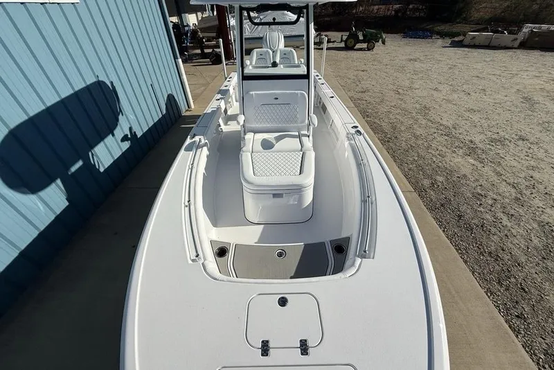 Slide: The Image of 2026 Sportsman Masters 247OE Bay Boat, sleek design, docked near blue building. - 37
