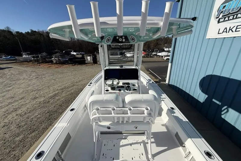 Slide: The Image of 2026 Sportsman Masters 247OE Bay Boat interior with helm and seating, docked outdoors. - 38