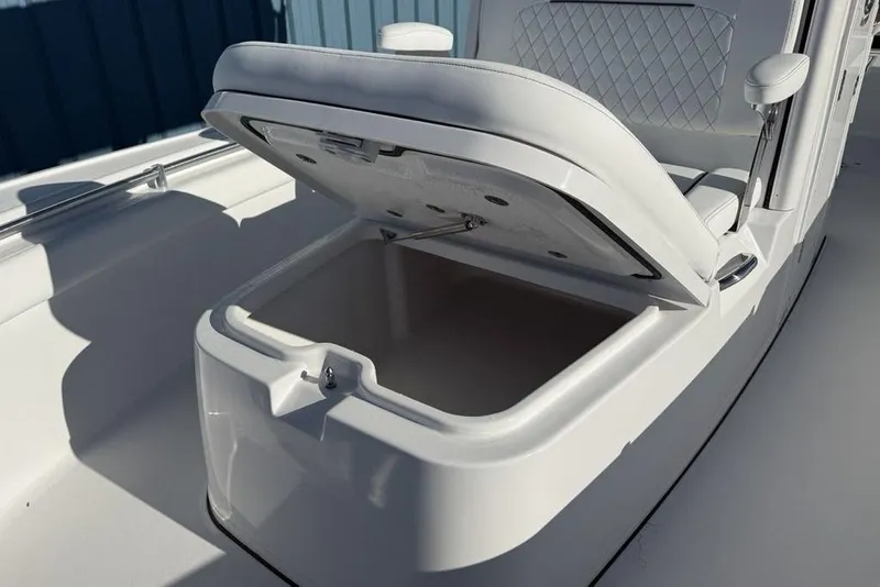 Slide: The Image of 2026 Sportsman Masters 247OE Bay Boat with open storage compartment. - 7