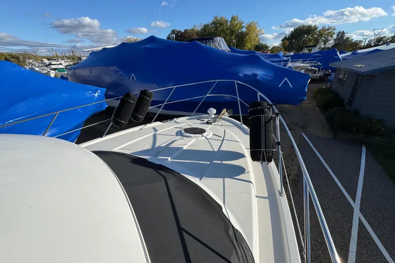Slide: The Image of 2005 Meridian 368 Motoryacht docked, surrounded by blue-covered boats under a clear sky. - 11