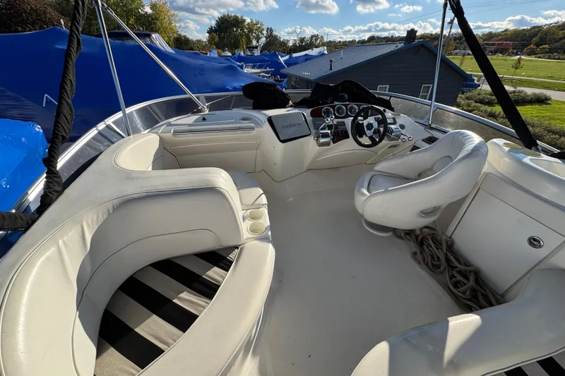 Slide: The Image of 2005 Meridian 368 Motoryacht cockpit with white seating and steering console. - 14