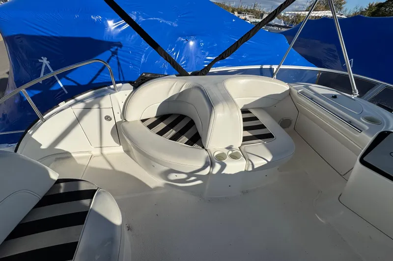 Slide: The Image of 2005 Meridian 368 Motoryacht interior with white seating and striped cushions. - 25