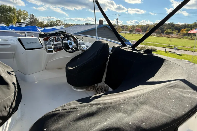 Slide: The Image of 2005 Meridian 368 Motoryacht helm with covered seats and Garmin navigation system. - 27