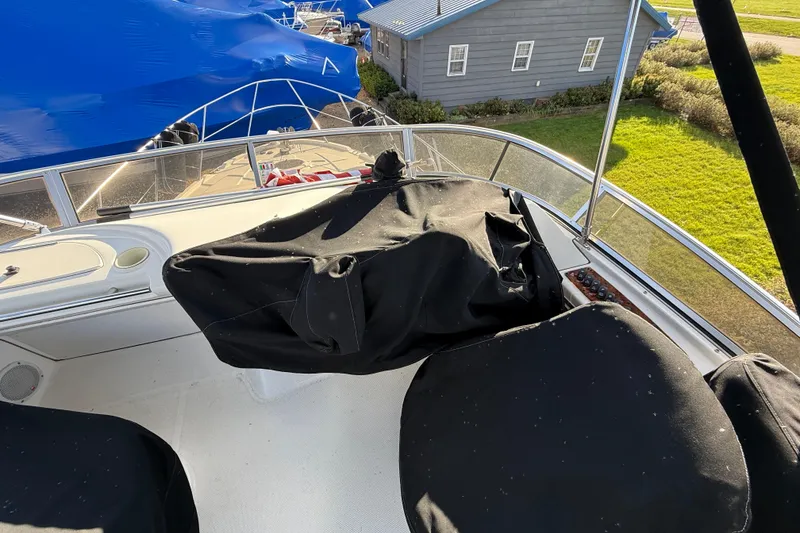 Slide: The Image of 2005 Meridian 368 Motoryacht deck with covered seating and scenic marina view. - 28