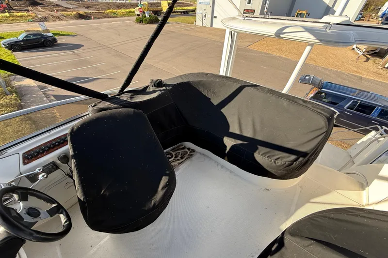 Slide: The Image of 2005 Meridian 368 Motoryacht helm with covered seating and steering wheel, docked in a marina. - 29